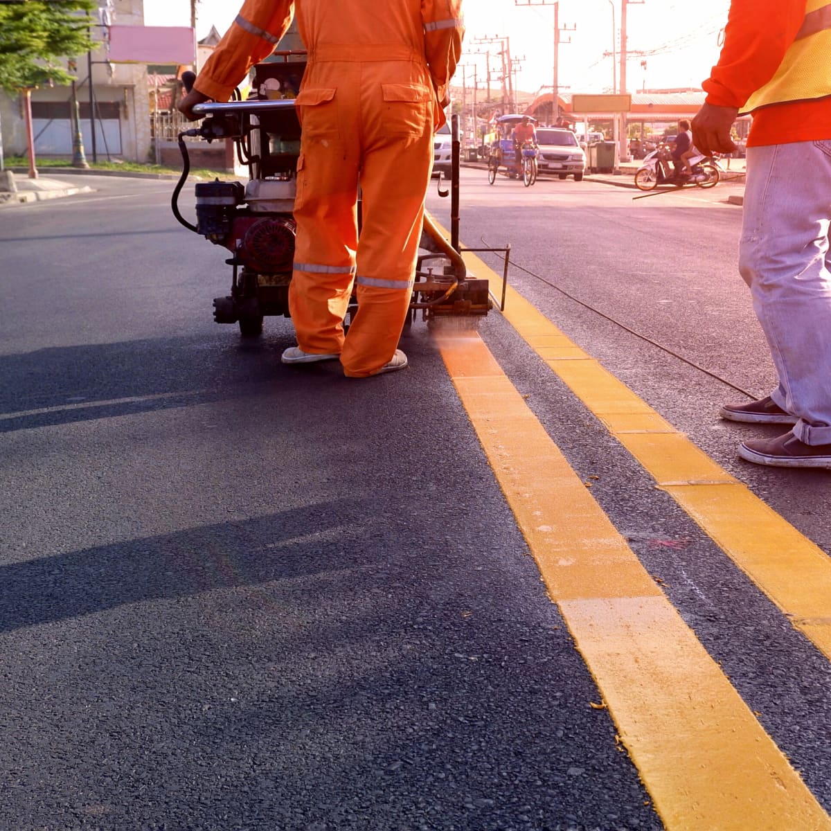 Worker painting road lines
